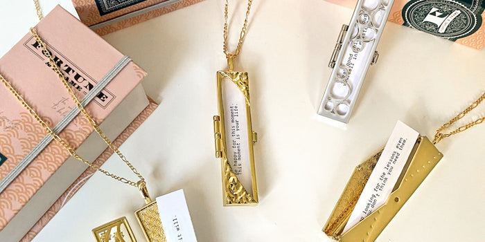 Several lockets with fortunes on a white background. Some boxes are spread around.